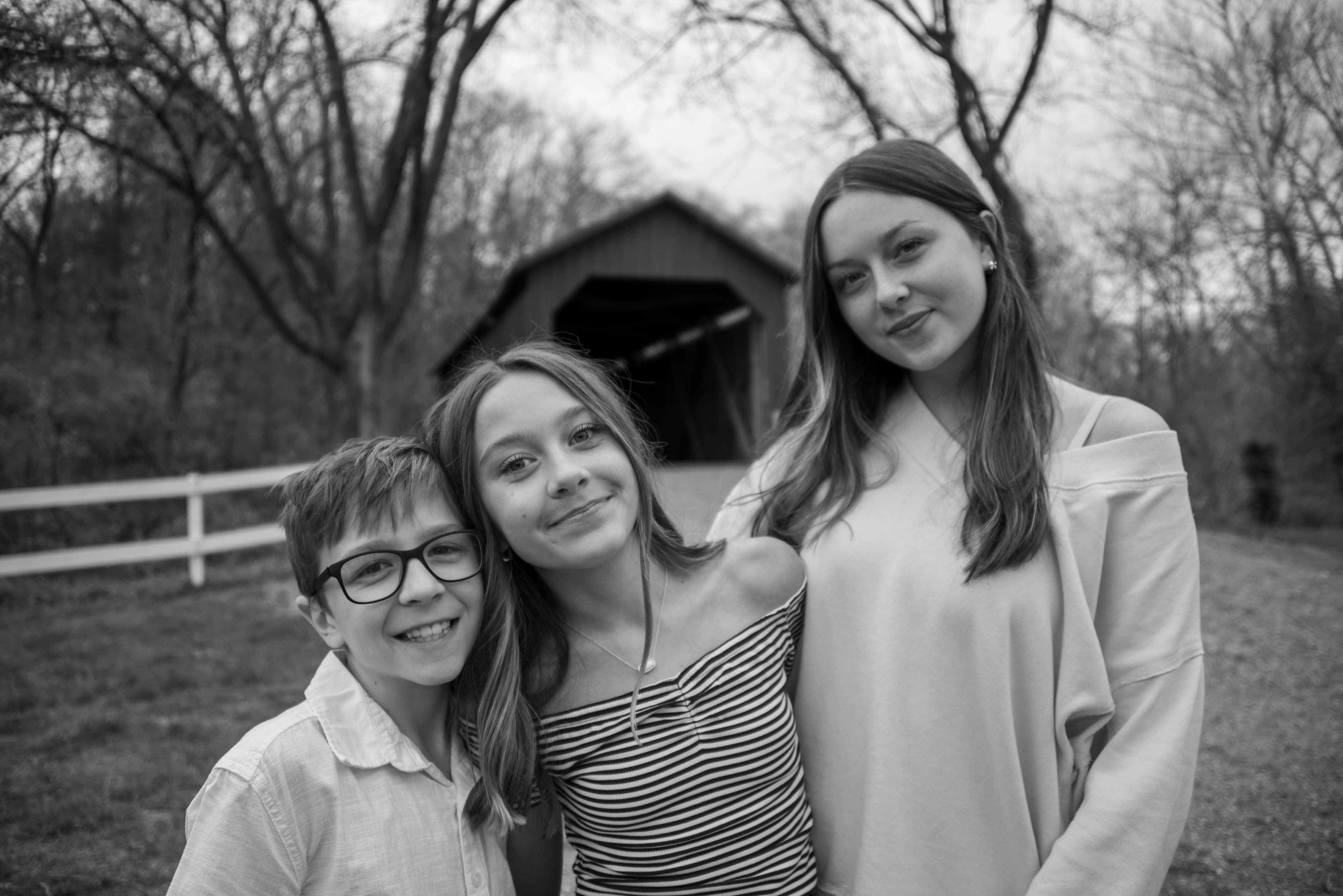 Siblings portrait at covered bridge